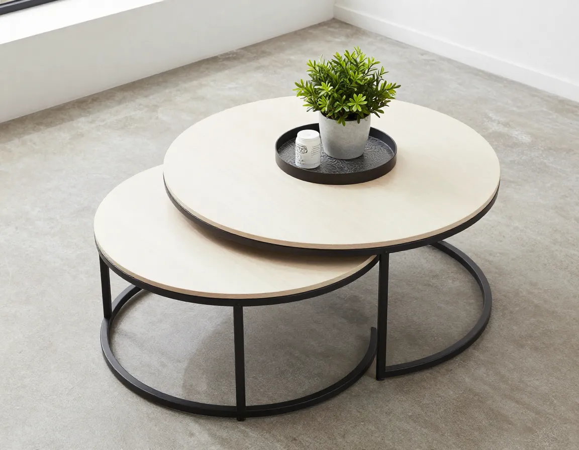 Modern round nesting coffee table with metal pedestal in smaller space